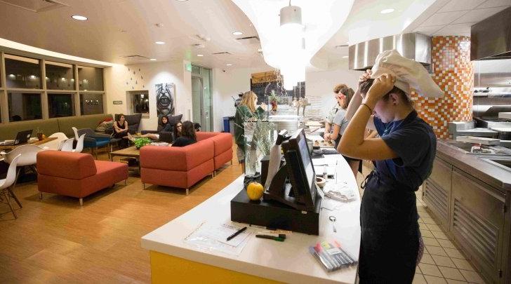 A Pitzer student puts on a chef hat in the Shakedown Cafe