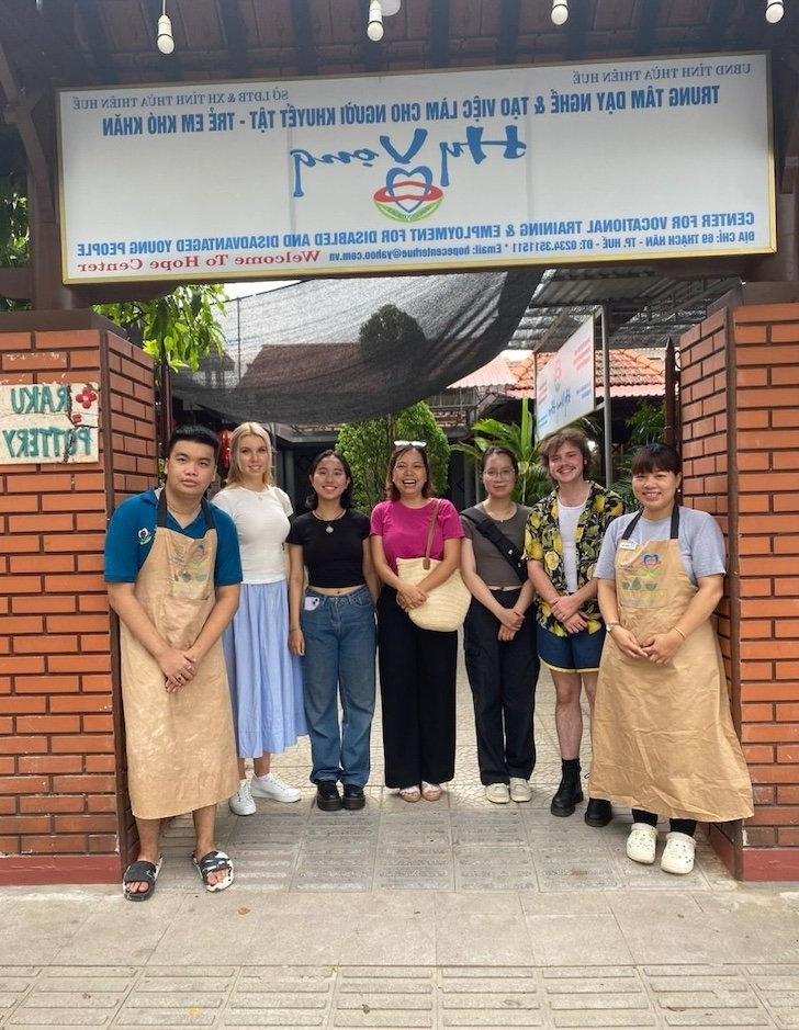 Group in front of sign for Hope Center Vietnam