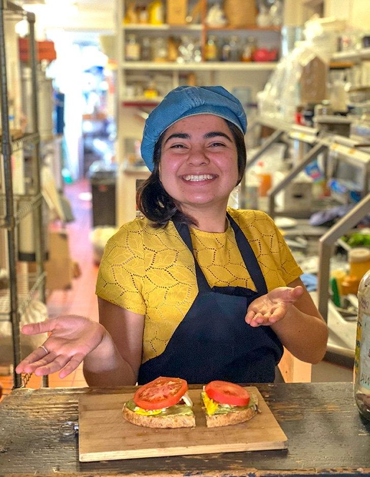 a grove house student workers displays a sandwich